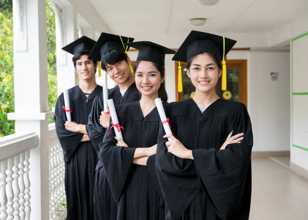 istock Group of multiethnic students with diplomas. 948575886