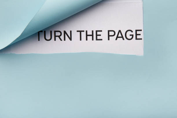 istock Text Turn the page on white paper behind blue folded corner 948576404