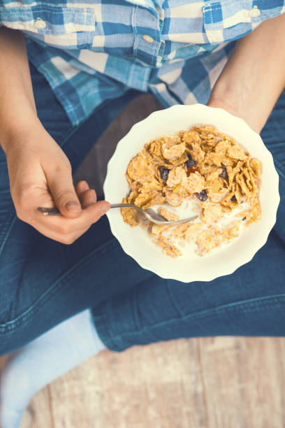 istock Girl with a plate of whole grain cereal 948577010