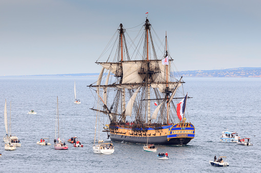 Low angle view of sailing ship and crane against clear sky, Hamburg harbor