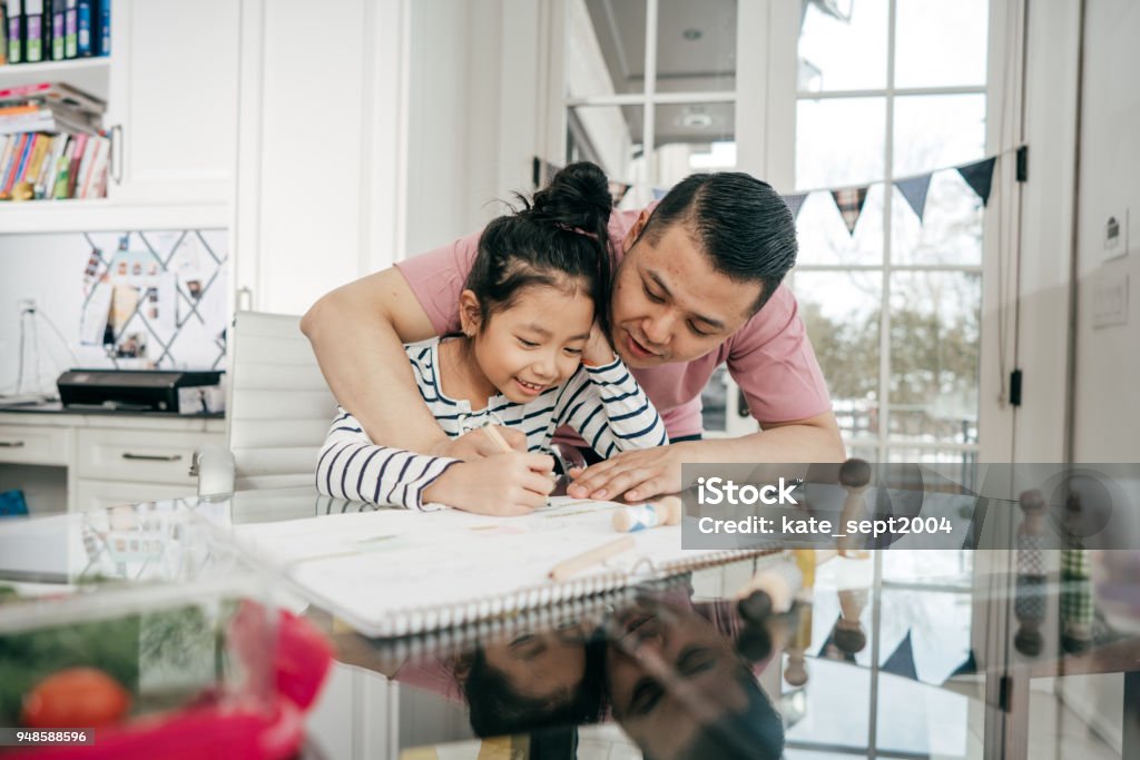 Helping with homework Dad helping with homework Domestic Life Stock Photo