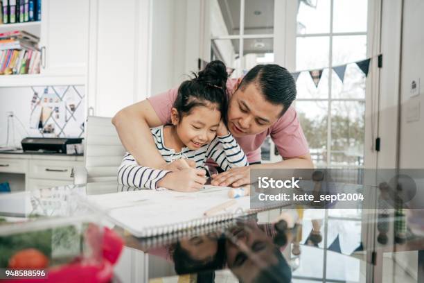 Helping With Homework Stock Photo - Download Image Now - Domestic Life, Family, 8-9 Years