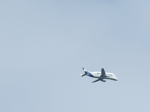 Wrexham, UK - May 23, 2015: Airbus super transporter Beluga 1. Outsized cargo carrying plane with distinctive bulbous shape. Flying low over Wrexham before landing at Hawarden Airport. Copy space.