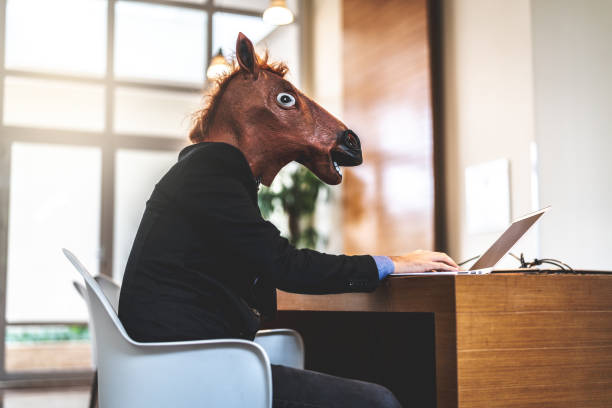 istock Business man with Horse Mask Working at Office 948589936
