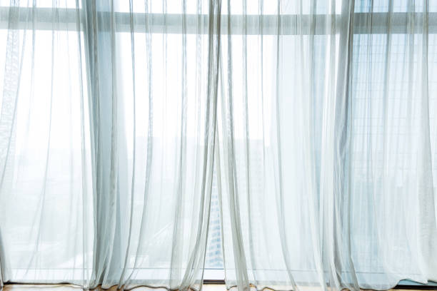 white curtain hanging in the window - indoors window elegance tranquil scene imagens e fotografias de stock