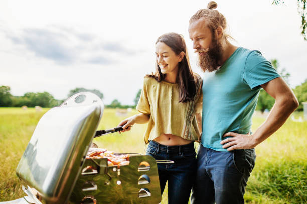 istock Couple Embrace While Cooking Lunch On BBQ 948594432
