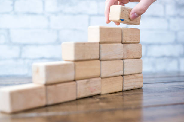 istock Making A Pile Of Blocks 948597166
