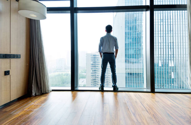 istock Businessman standing and looking at cityscape 948600510