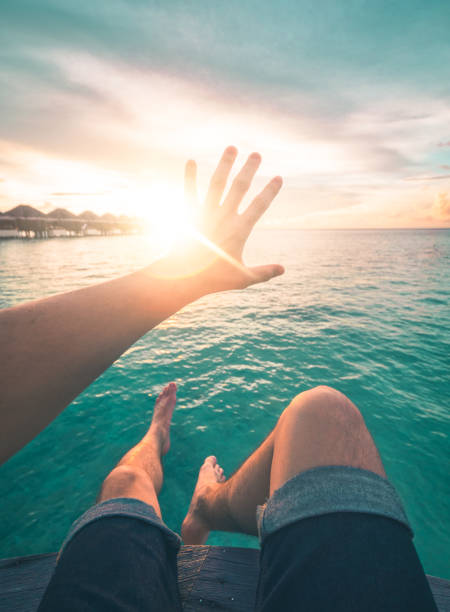 istock Young Man Watching the Sunset in Maldives 948603136
