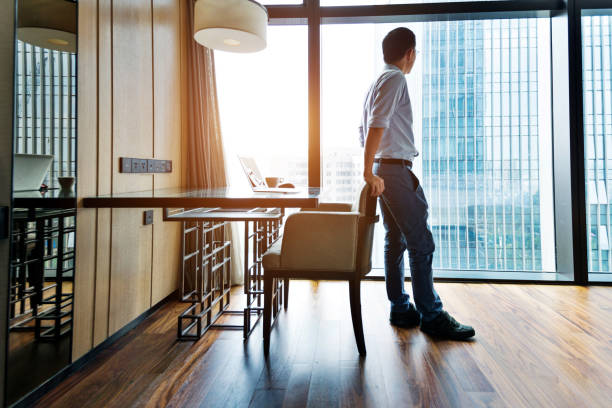 istock Businessman standing and looking at cityscape 948605700