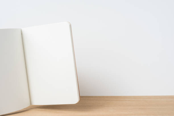istock front view of floating kraft notebook and  on wooden desktop and white background for mockup 948606046