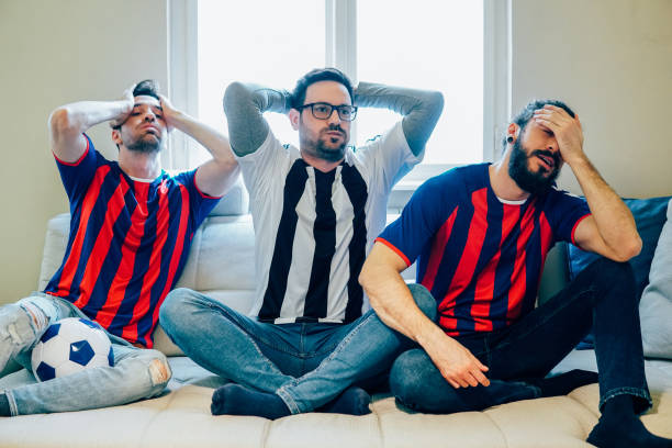 istock Irritated male friends watching soccer game 948609674