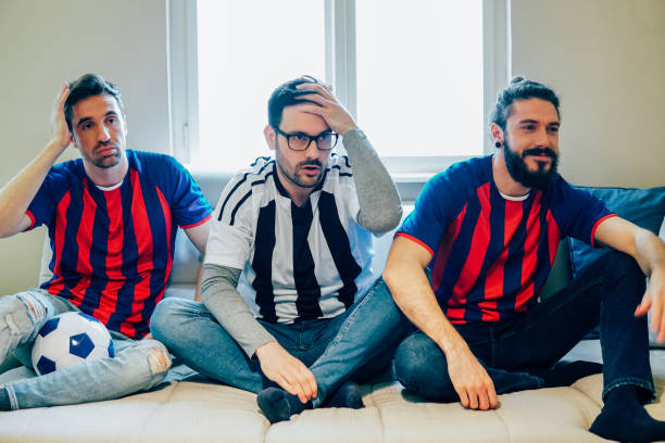 istock Three male football supporters 948609782