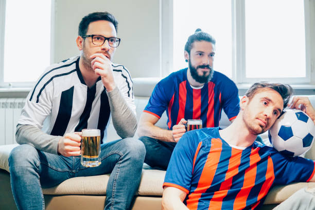 istock Friends watching soccer game and drinking beer 948609838