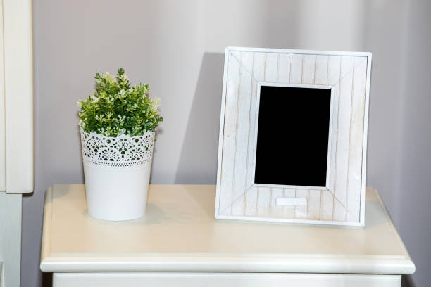 istock White empty photo frame on the chest of drawers 948610256