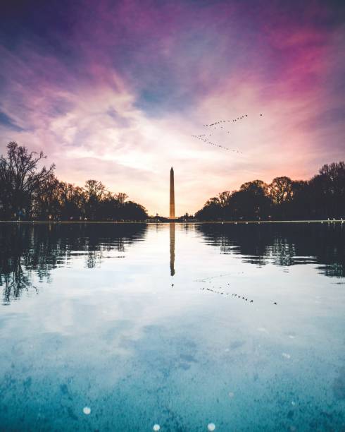 Washington Monument Washington Monument at sunset in front of the reflecting pool. national monument stock pictures, royalty-free photos & images
