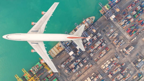 istock Container ships and transport aircraft in the export and import business and logistics international goods. Shipping cargo to harbor by crane. Aerial view and top view. 948614310