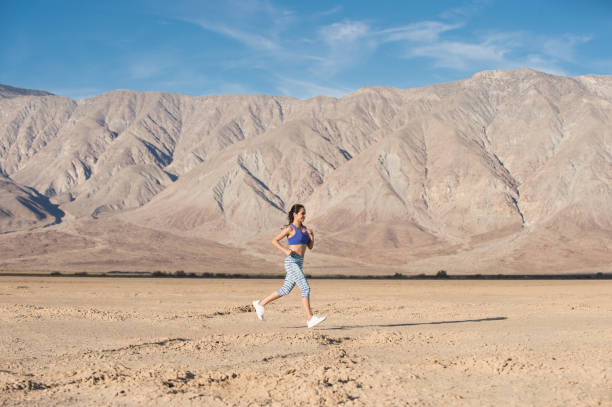 istock Female Runner In The Desert 948624344