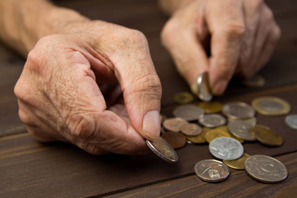 istock Hands of beggar with few coins 948628764