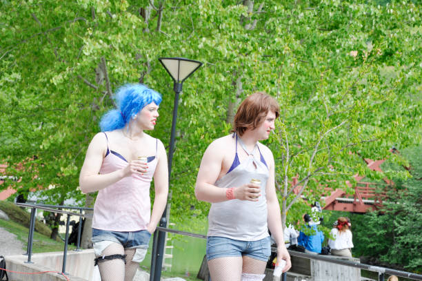 Drags Two male students dressed as drag during an annual student summer event at the Mid Sweden University, Sundsvall, Sweden. Each holding a can of beer. students cross-dressing stock pictures, royalty-free photos & images
