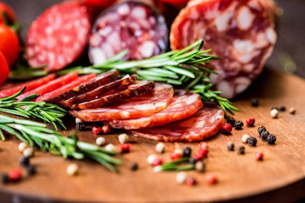 istock Three types of salami with herbs and peppercorn 948643194