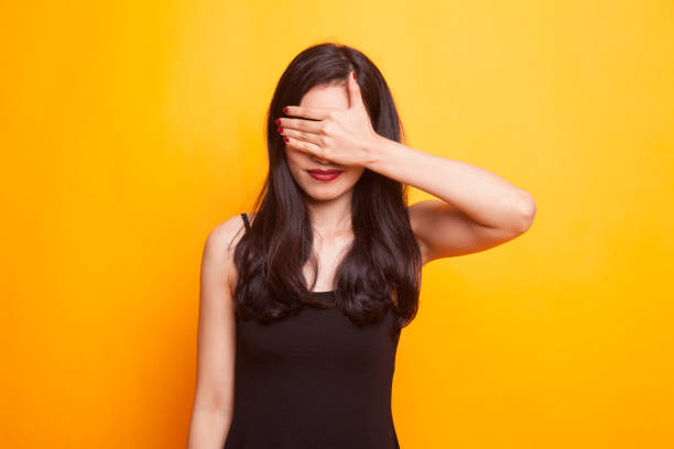 istock Young Asian woman close her mouth with hand. 948643582