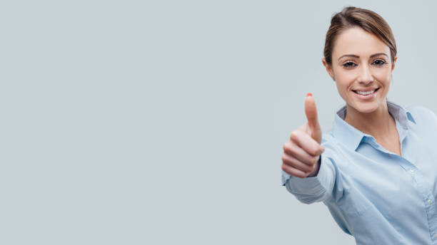 istock Confident female business executive giving a thumbs up 948645964