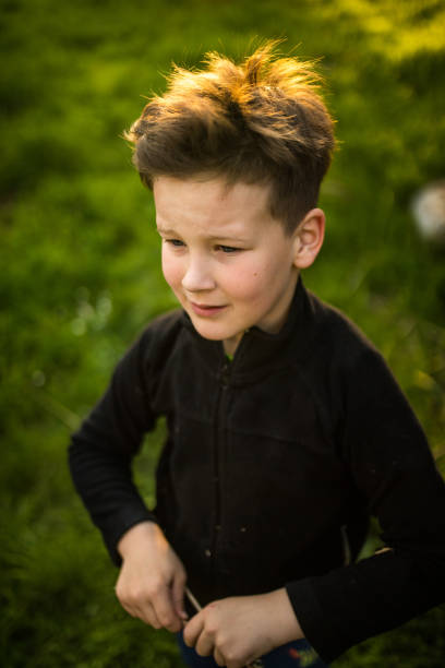 istock Little Boy With a Stick in nature 948654518