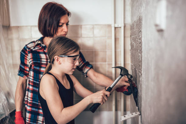 istock Daughter and mother removing kitchen wall tails 948655504