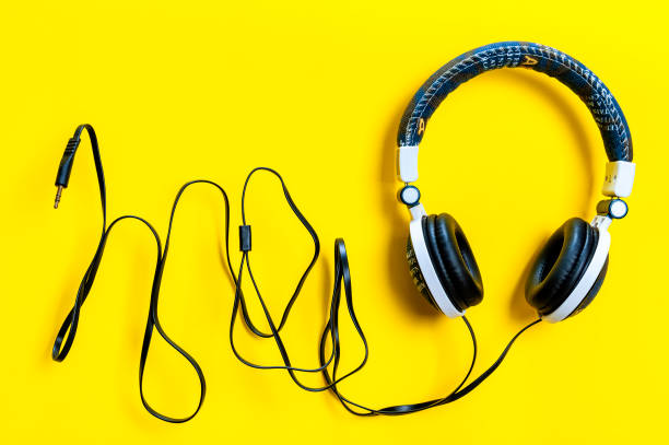 istock Jeans jacket headphone on yellow background, isolated 948659100