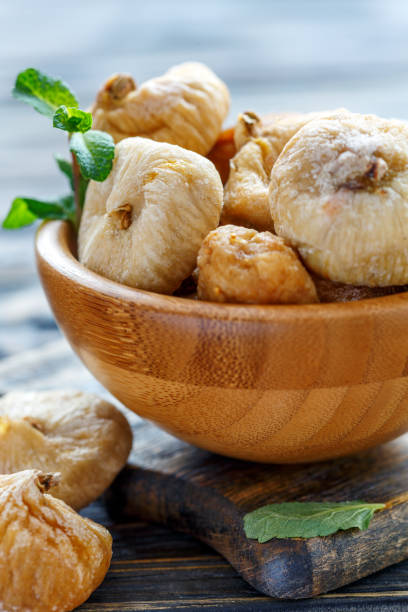 istock Wooden bowl with dried figs. 948667416