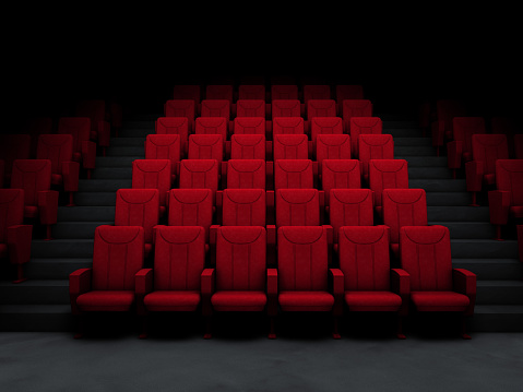 Red auditorium chairs. Empty movie theater seats