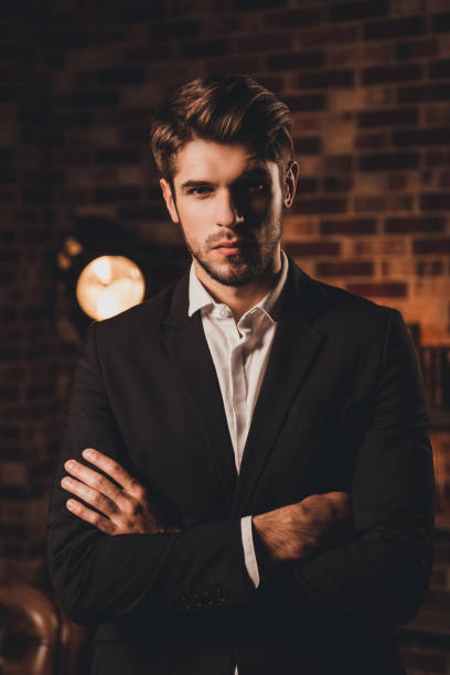 istock Confident well-dressed handsome young businessman with crossed hands 948671034