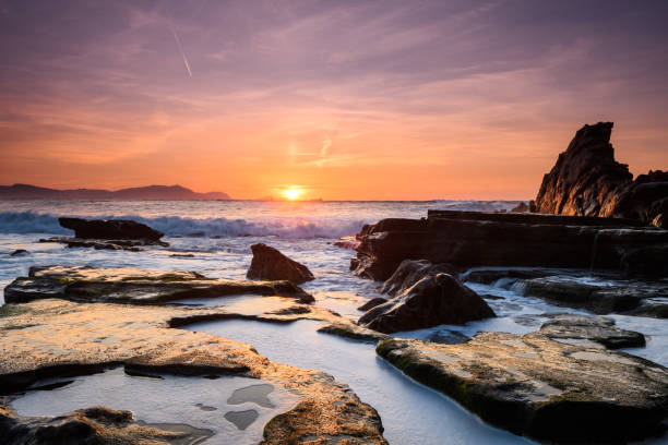 istock amazing sunset landscape at rocky beach 948671154