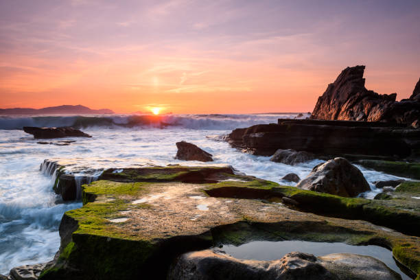 istock amazing sunset landscape at rocky beach 948671212