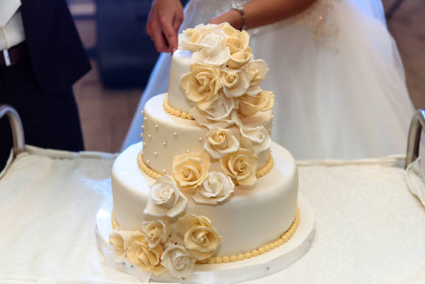 istock luxury wedding cake decorated with roses at wedding reception, catering in restaurant 948671828