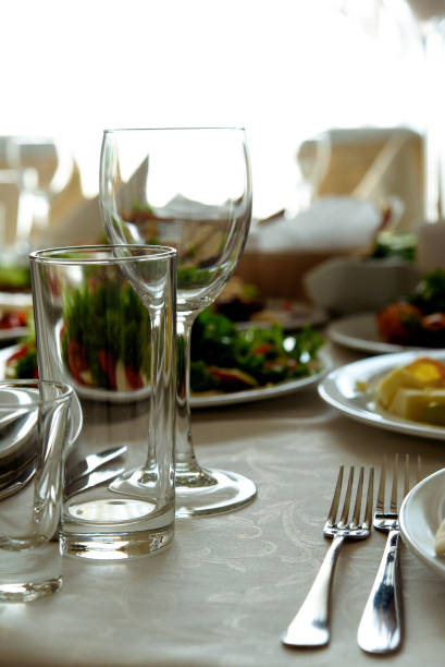 istock stylish glasses at luxury decorated round tables at wedding reception in restaurant 948671874