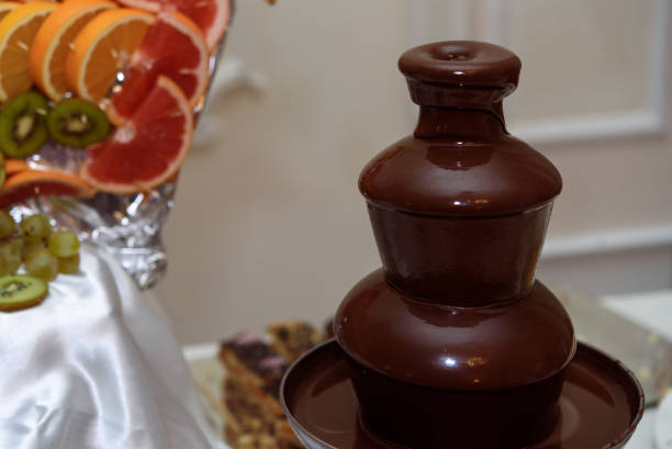 delicious  chocolate fountain fondue at candy bar at luxury wedding reception - wedding reception fountain chocolate candy wedding imagens e fotografias de stock