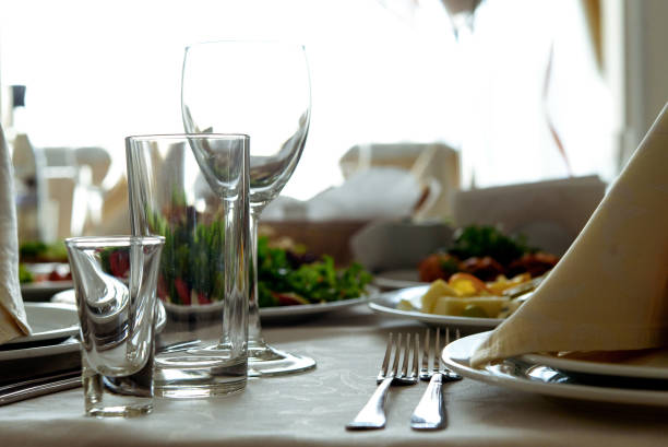 istock stylish glasses at luxury decorated round tables at wedding reception in restaurant 948673432