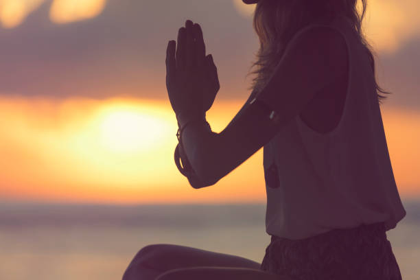 istock Young woman practicing yoga on the tropical beach. 948675210