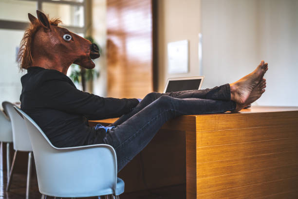istock Business man with Horse Mask Working at Office 948678376