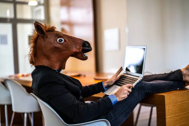 Photo of Business man with Horse Mask Working at Office