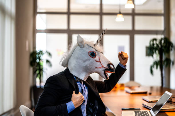 istock Business man with Unicorn Mask Celebrating 948679412