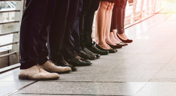 istock Low Section Of People Standing On Walkway 948679594