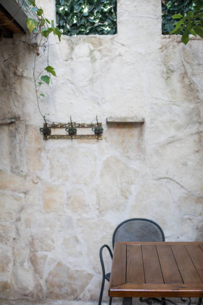 istock Table and Chair In Front Of Stone Wall Patio Area 948686970