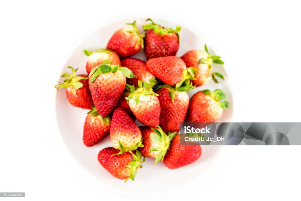 strawberries in white porcelain dish with white background Berry Stock Photo