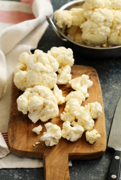 istock Fresh cauliflower on wooden cooking board 948691092