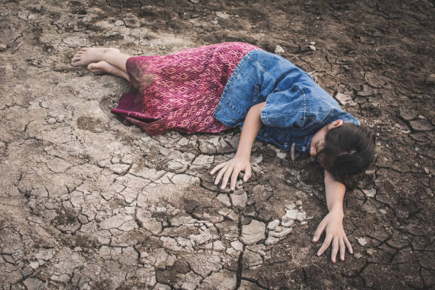 istock High Angle View Of Girl Lying On Arid Field 948698468