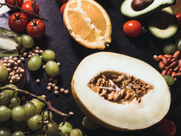 istock sliced tropical fruits with nuts on the dark black surface 948716742