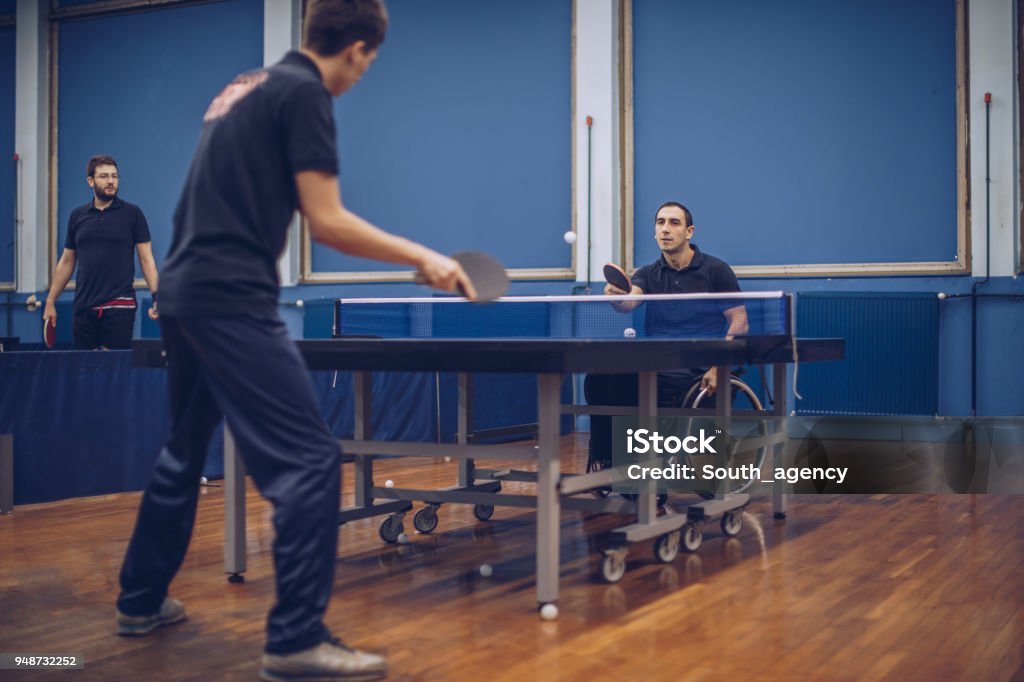 Table tennis club Man in a wheelchair playing table tennis Accessibility for Persons with Disabilities Stock Photo